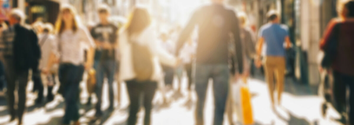 crowd of people in a shopping street, defocused background