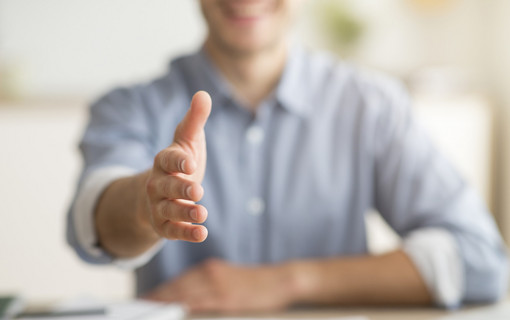 Unrecognizable Young Man Stretching Hand For Handshake Greeting At Home