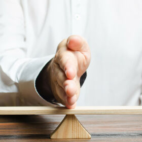 The family lawyer shares the figure of a man and a woman on scales. The concept of divorce and division of property. Solving family disputes. Arbitration Services. Gender pay gap